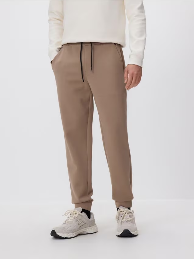 Reserved - Spodnie dresowe slim fit - beżowy